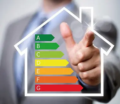 A man pointing to an energy efficiency chart in the shape of a house.